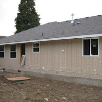 The back of the house. Windows installed and doors are going in.