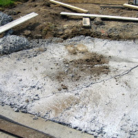 <strong>BEFORE:</strong> Can you imagine having this as your driveway? We were brought in on this project when another crew had failed miserably at pooring the concrete for the driveway.