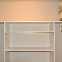 Walk in closet with built in cabinets.